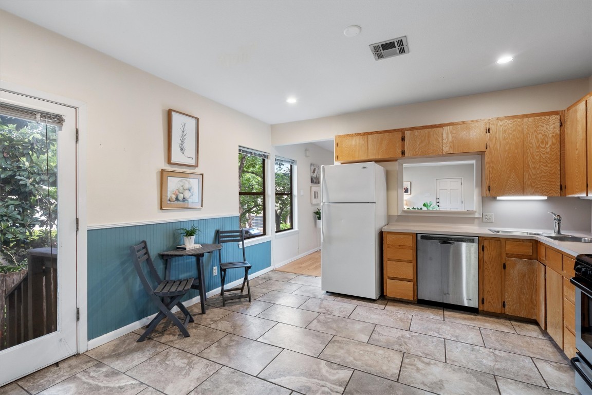 2116 Glendale Place Austin, TX 78704 - Photo 10 of 24 a kitchen with refrigerator and cabinets
