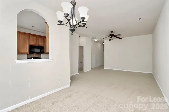 a view of a chandelier fan and entryway