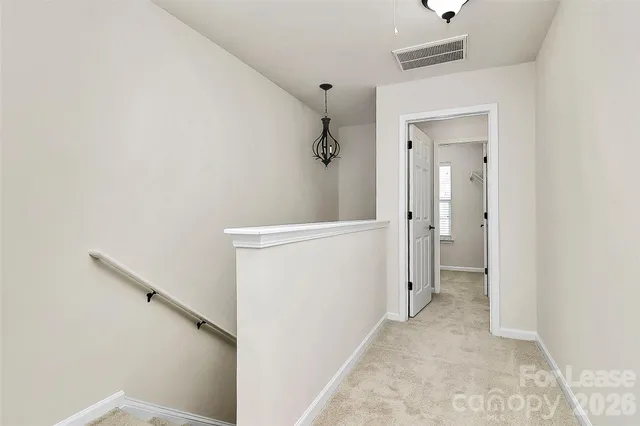 a view of a hallway with wooden floor and a hallway
