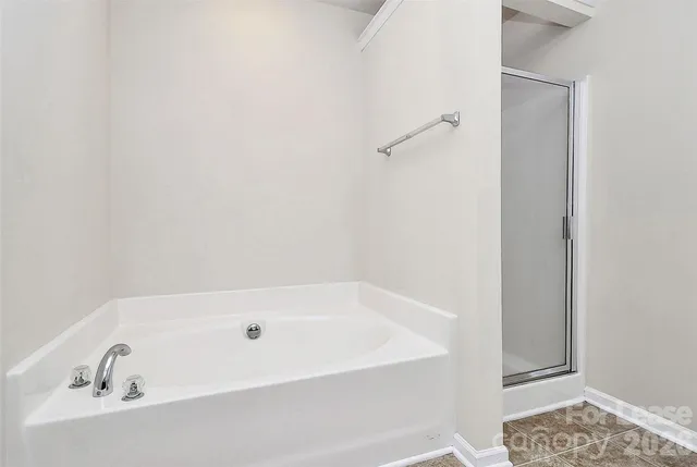 a bathroom with a tub and a shower