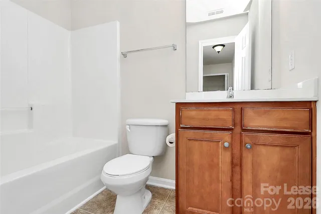 a bathroom with a toilet sink and shower