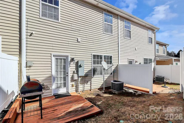 a backyard of a house with barbeque oven table and chairs