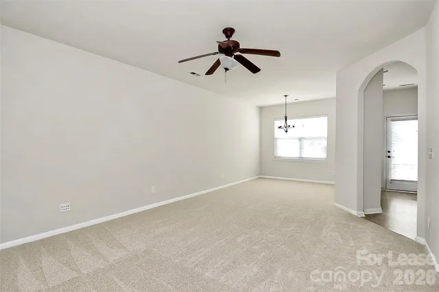 a view of an empty room and a window