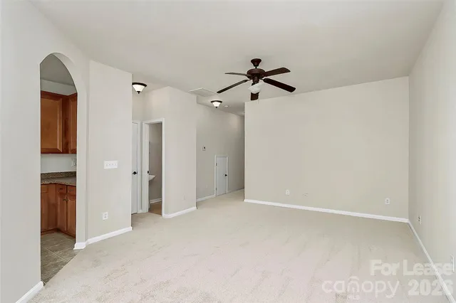 a view of a big room with closet and windows