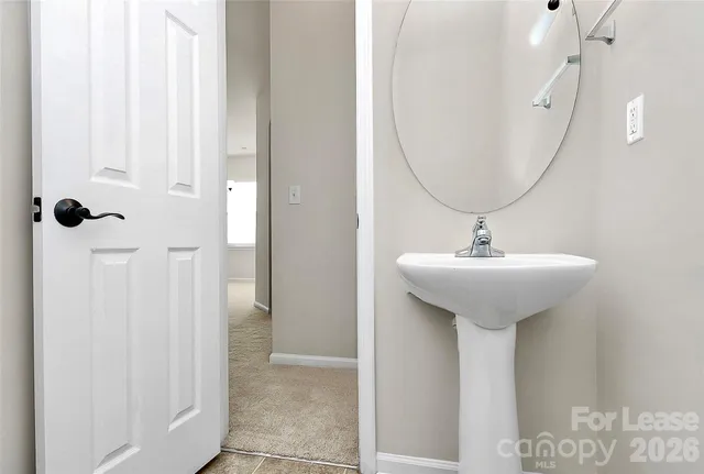 a bathroom with a sink a mirror and shower