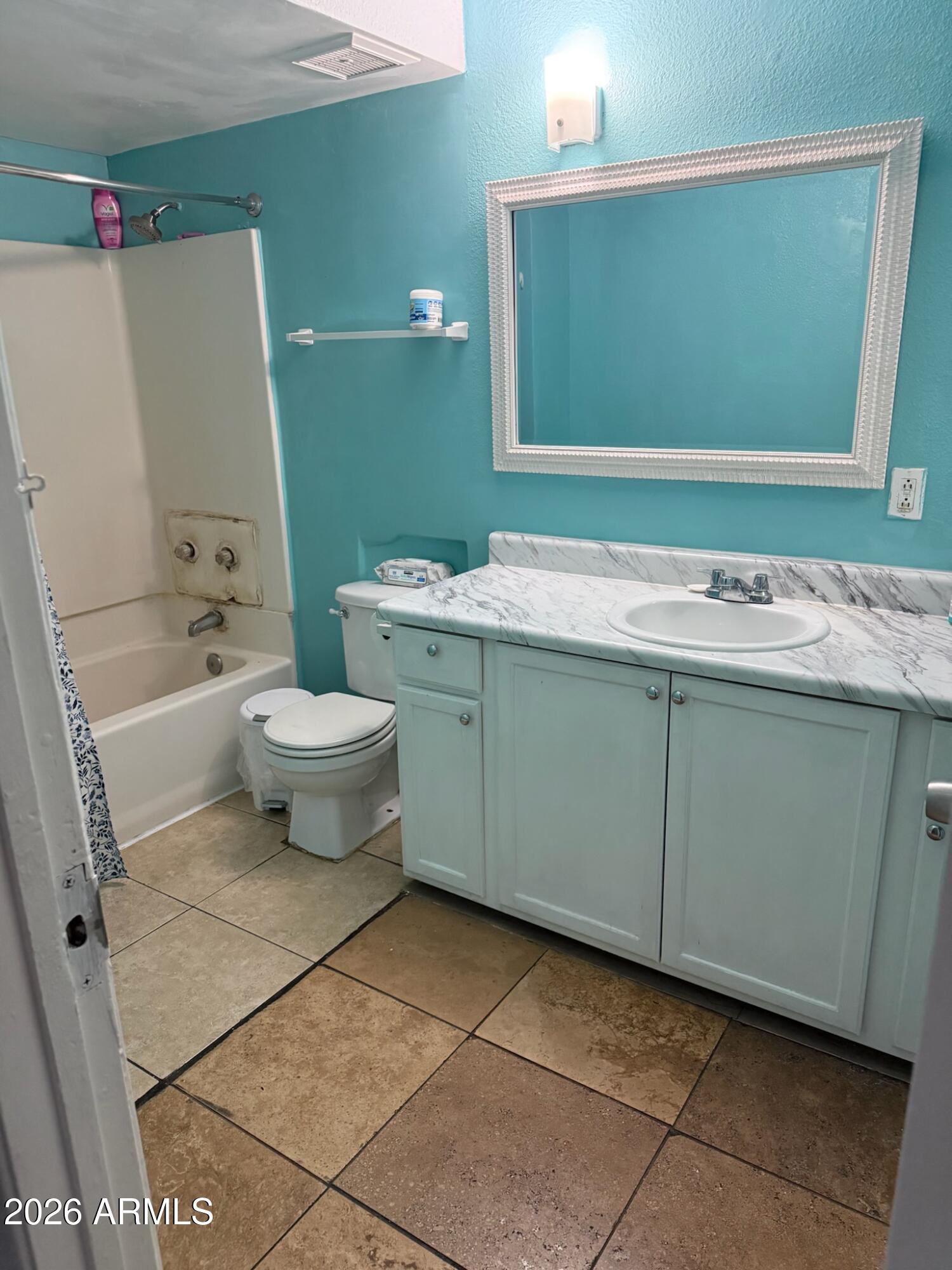 3105 West Madison Street Phoenix, AZ 85009 - Photo 7 of 8 a bathroom with a sink toilet and mirror