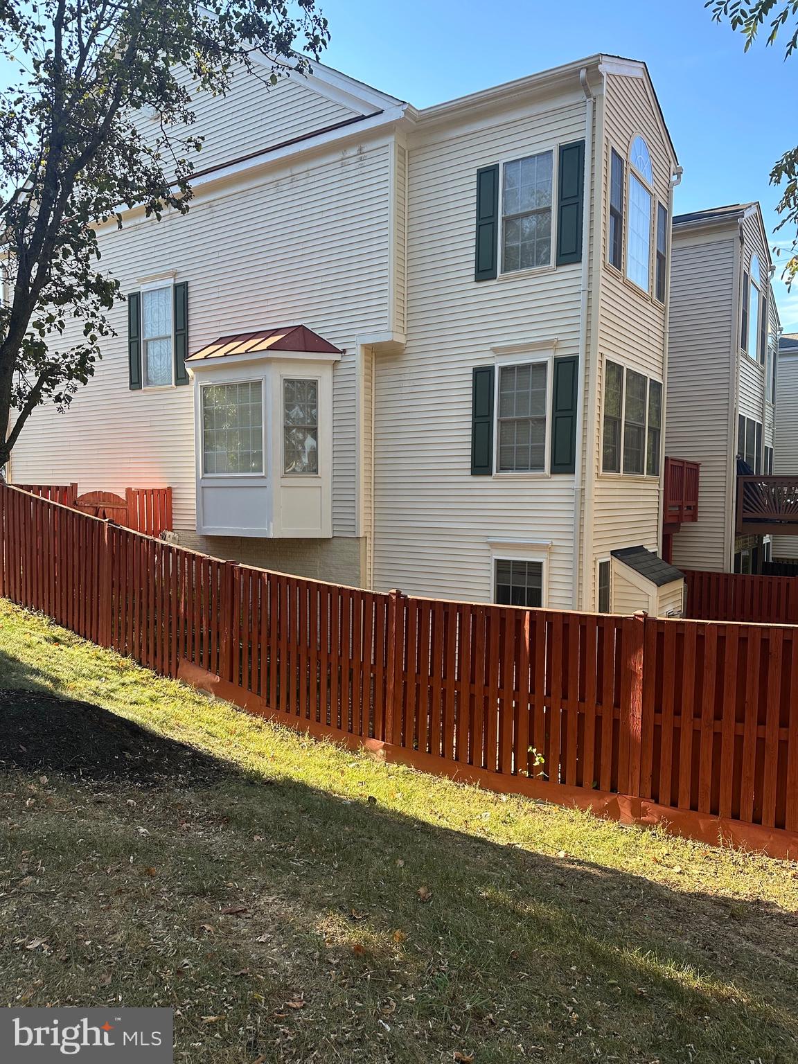 9077 Two Bays Road Lorton, VA 22079 - Photo 20 of 22 a front view of a house with a yard with wooden fence
