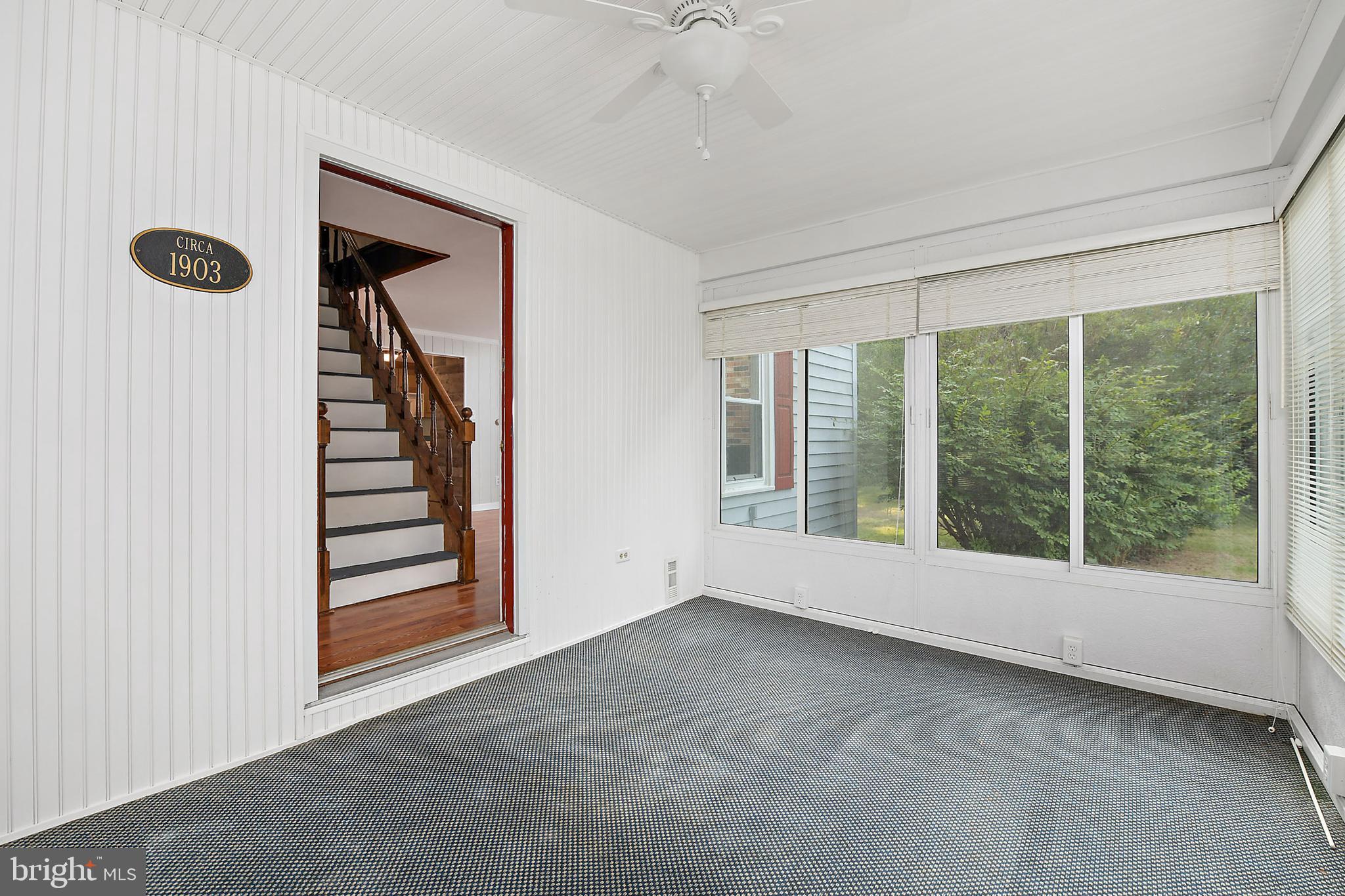 10826 Brownstone Road Princess Anne, MD 21853 - Photo 40 of 68 a view of an empty room with windows and stairs