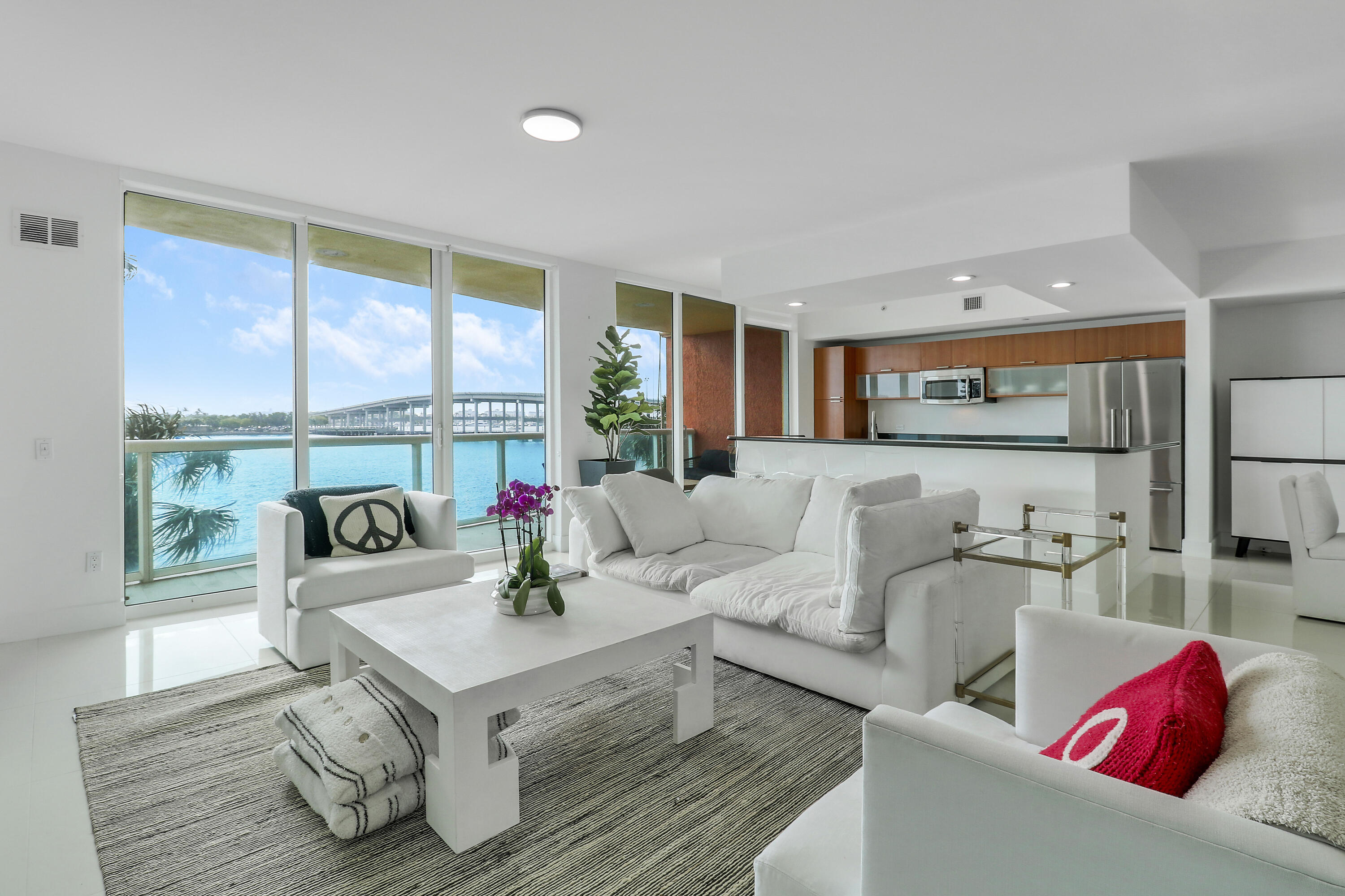 2640 Lake Shore Drive, Unit 307 Riviera Beach, FL 33404 - Photo 4 of 44 a living room with furniture and a large window