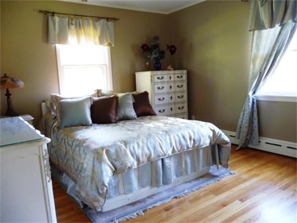 111 Scully Road Somers, CT 06071 - Photo 8 of 26 a bedroom with a bed and wooden floor