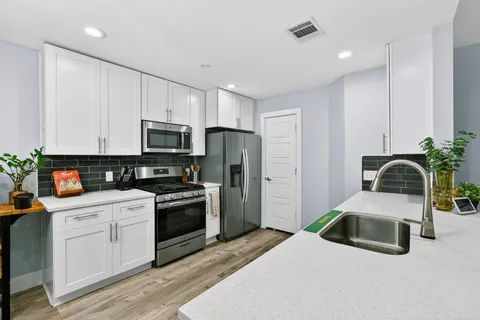 a view of kitchen with cabinets and wooden floor