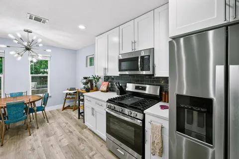 a kitchen with appliances a sink and a counter top space