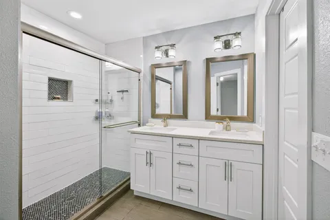 a bed sitting in a bedroom next to a cabinet