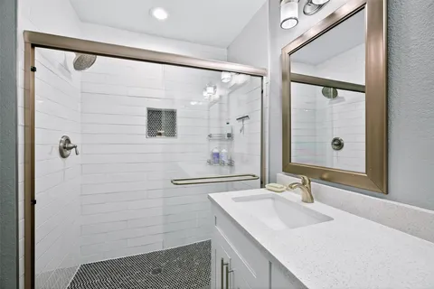 a bathroom with a double vanity sink and mirror