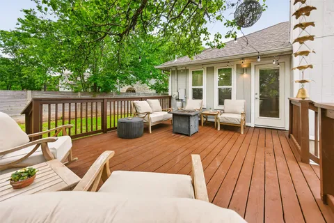a view of a balcony with wooden floor and furniture