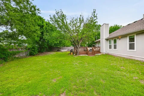 a view of a house with wooden deck and furniture