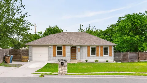 a view of a backyard with table and chairs and wooden fence