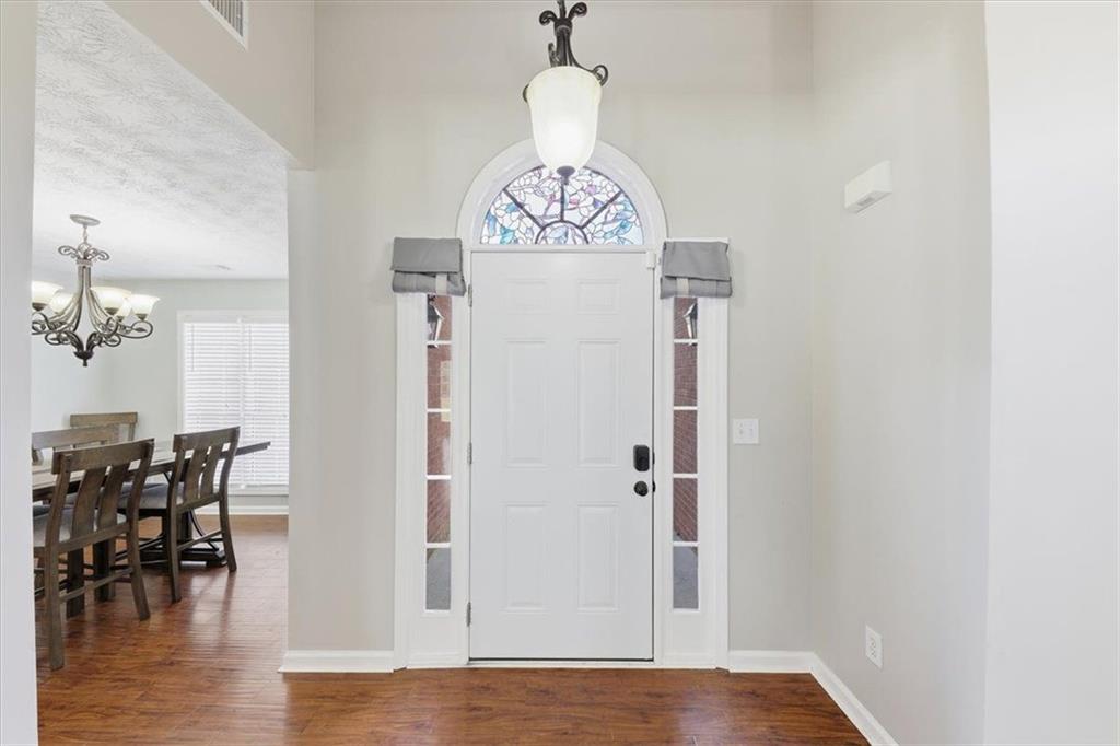 493 Youth Jersey Road Covington, GA 30014 - Photo 7 of 52 a view of a dining room with furniture window and wooden floor