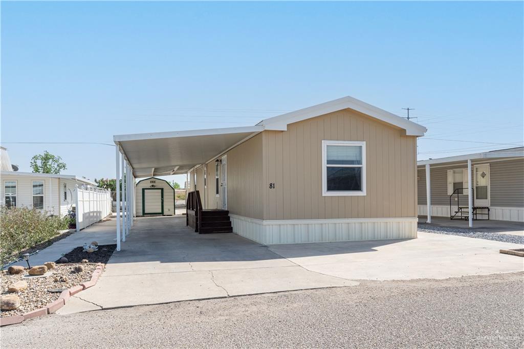 215 South Valley View Road, Unit 81 Donna, TX 78537 - Photo 1 of 1 a front view of a house with glass windows and yard