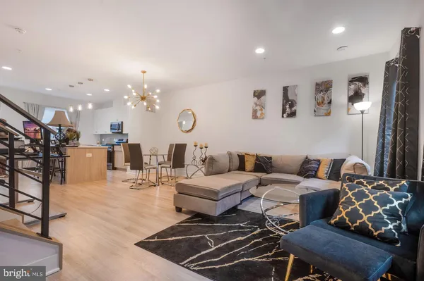 a living room with furniture and a chandelier