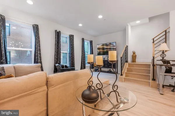 a living room with furniture and a floor to ceiling window