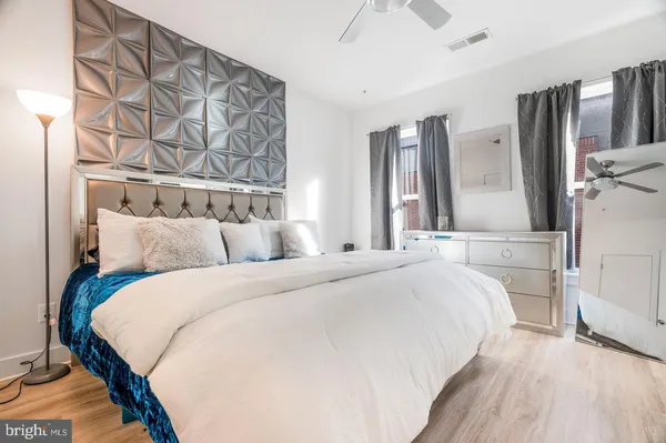 a bed room with a bed and a chair