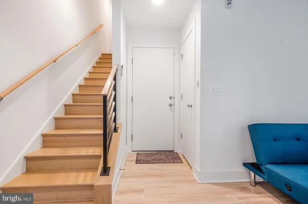 a view of entryway and gallery with wooden floor