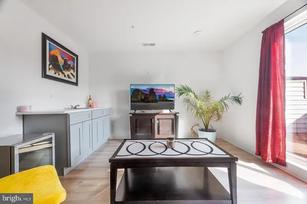 a living room with furniture and a floor to ceiling window