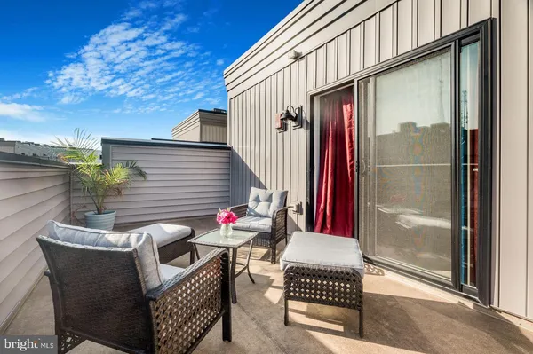 a view of a terrace with furniture and a potted plant