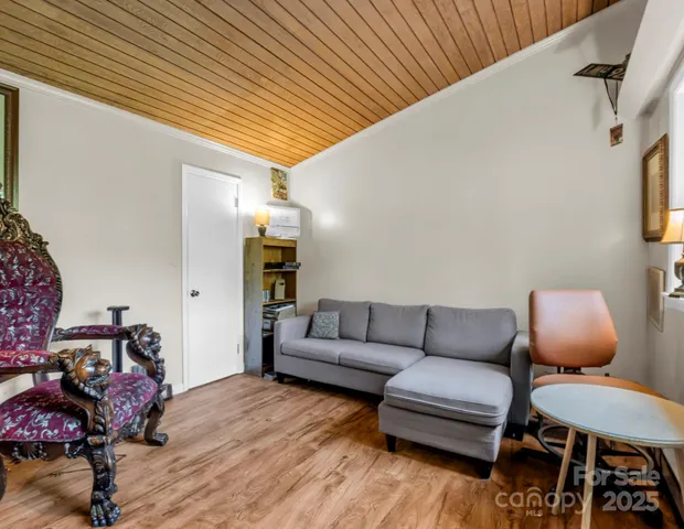 a dining room with furniture and a potted plant
