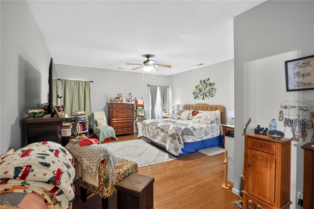 144 Elliott Circle Anderson, SC 29621 - Photo 14 of 30 Hardwood floors and a ceiling fan create a comfortable atmosphere in this inviting primary bedroom.