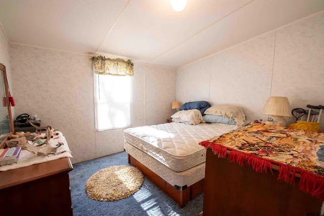 a bedroom with two beds and a window