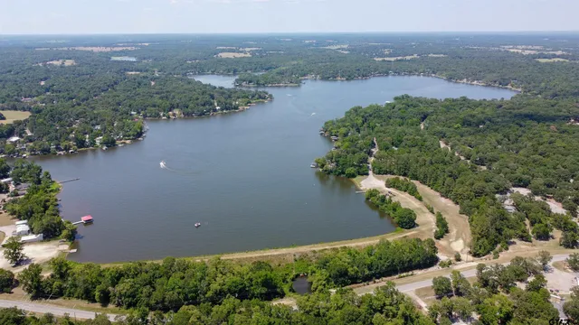 an aerial view of lake and residential houses with outdoor space