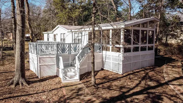 a view of a house with a small yard and wooden fence