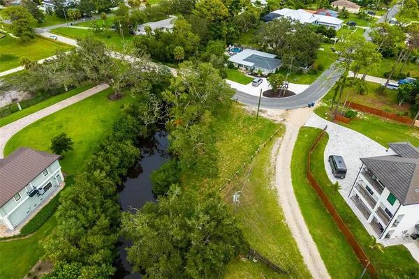 an aerial view of a house with a yard and swimming pool