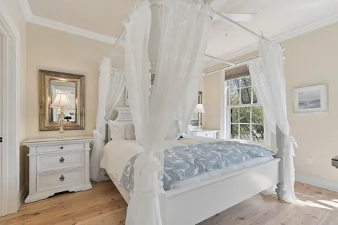 a bed room with a bed and a large window