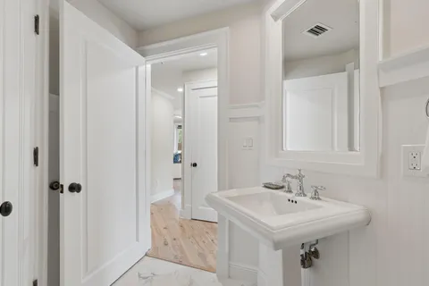 a bathroom with a sink a mirror and a shower