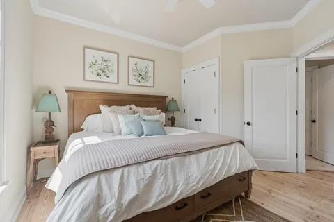 a bedroom with a bed and painting on the wall