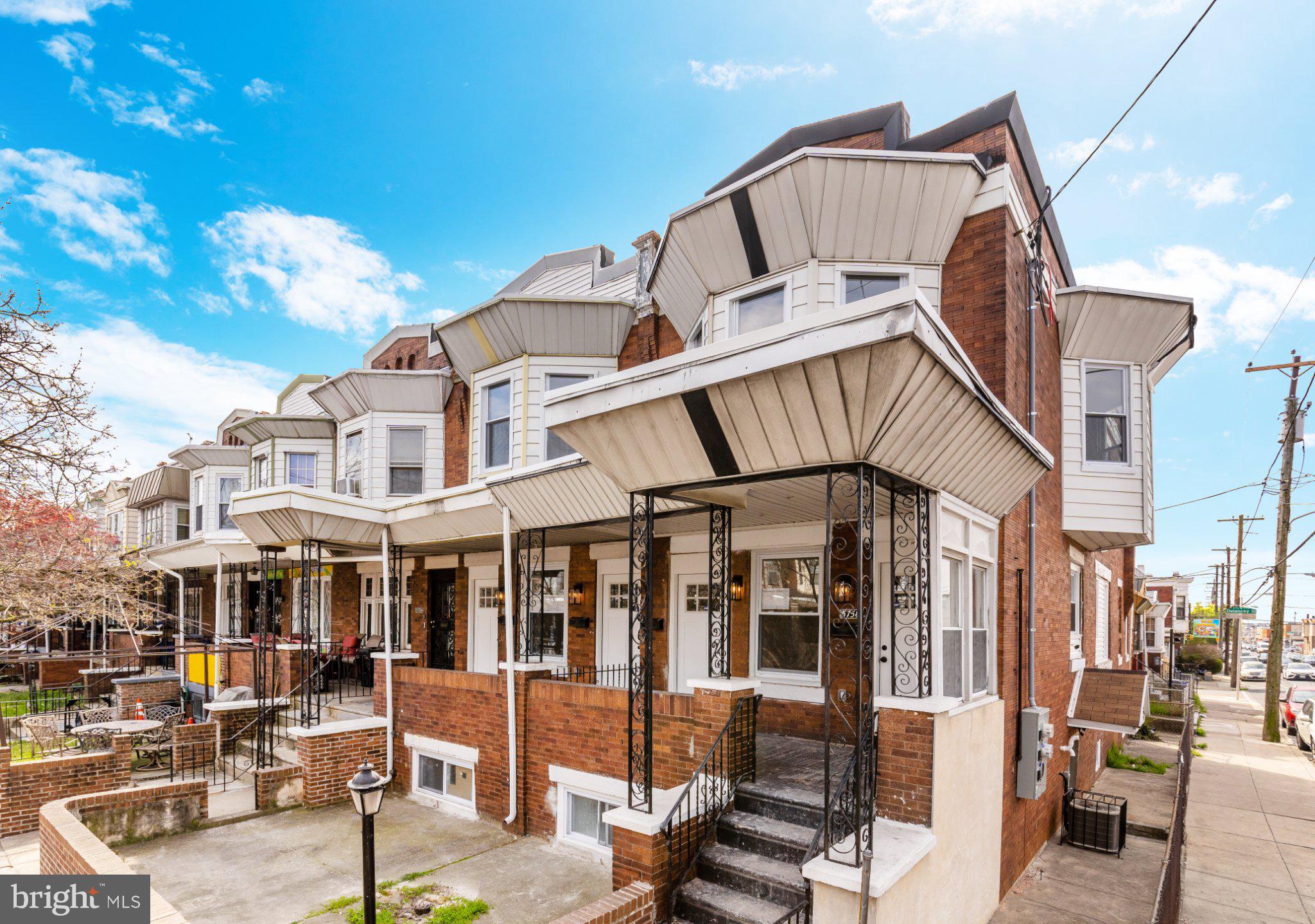 Charming brick row homes under blue skies.