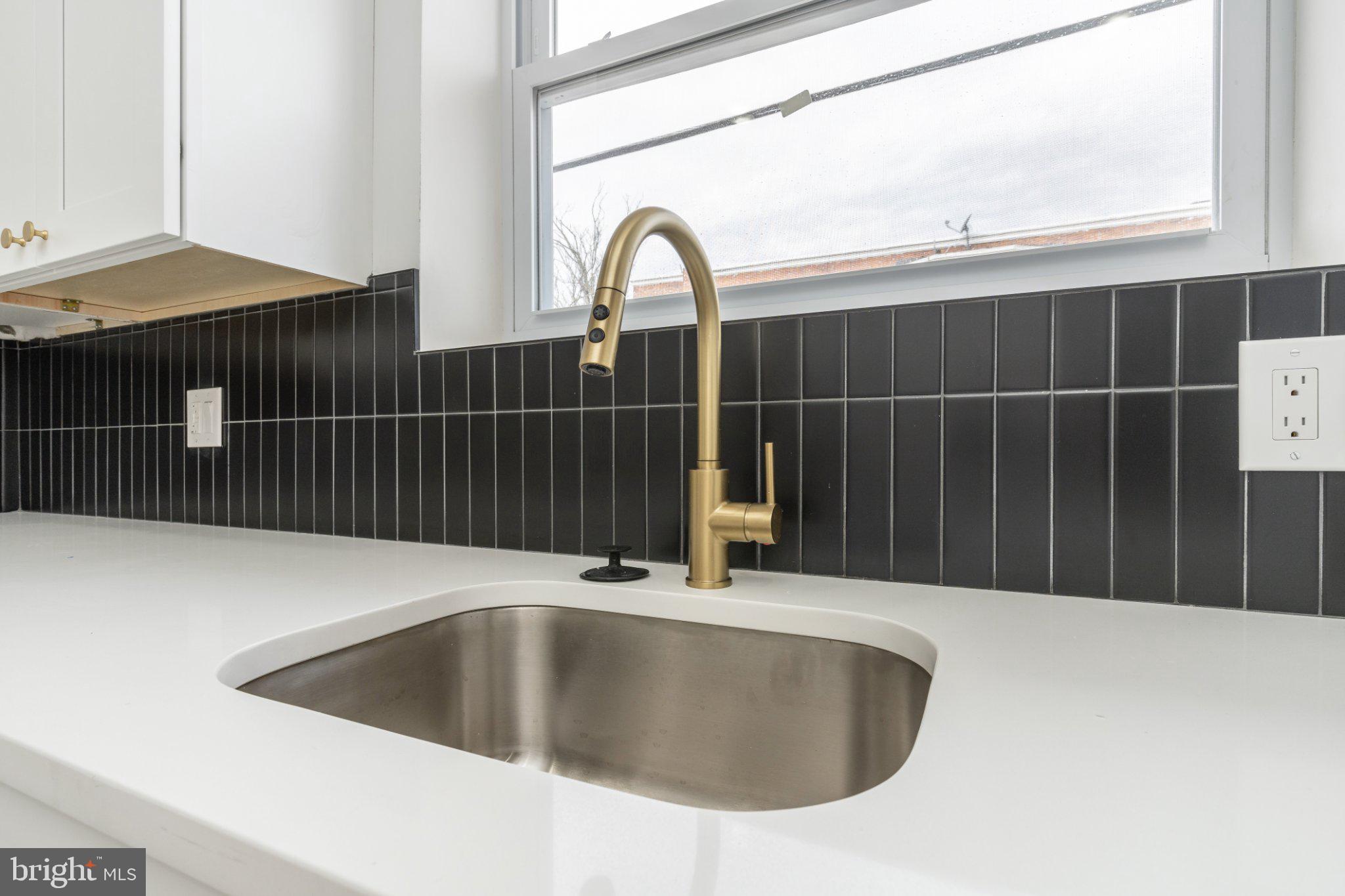 5758 Spruce Street Philadelphia, PA 19139 - Photo 8 of 44 Sleek kitchen sink with modern faucet.