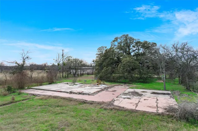a view of outdoor space with green field and trees