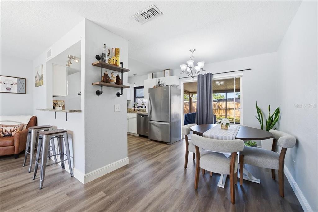3487 Begonia Place Largo, FL 33771 - Photo 18 of 34 a view of a dining room with furniture and wooden floor