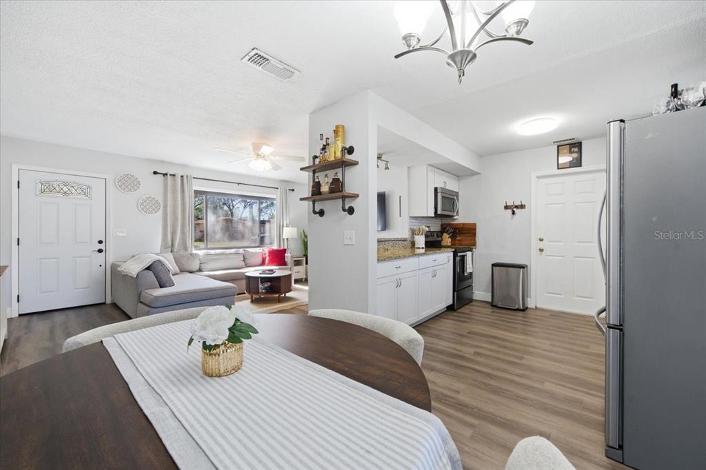 3487 Begonia Place Largo, FL 33771 - Photo 19 of 34 a living room with furniture and kitchen view