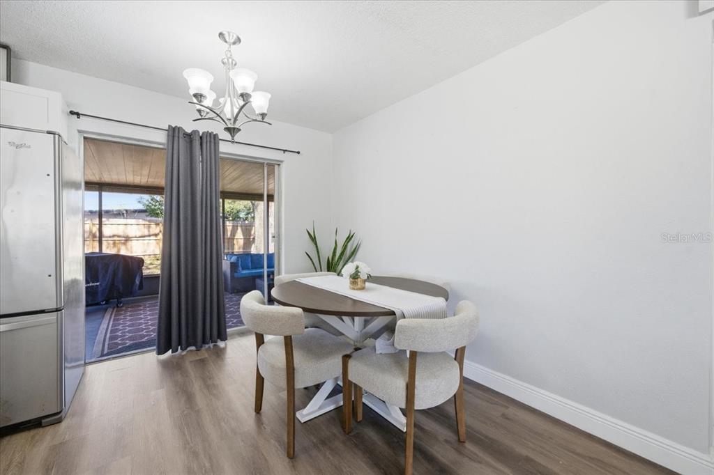 3487 Begonia Place Largo, FL 33771 - Photo 20 of 34 a view of a dining room with furniture wooden floor and chandelier