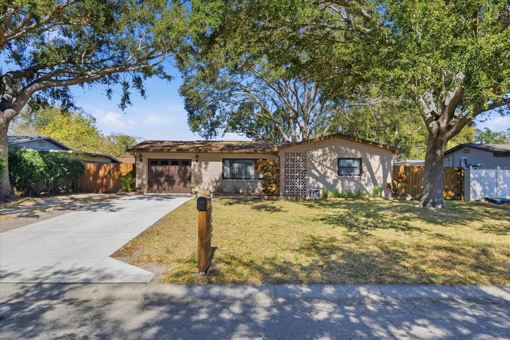 3487 Begonia Place Largo, FL 33771 - Photo 2 of 34 a front view of a house with a yard outdoor seating and yard