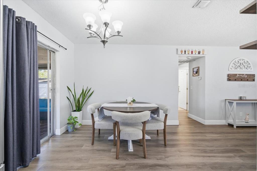 3487 Begonia Place Largo, FL 33771 - Photo 22 of 34 a view of a dining room with furniture and wooden floor