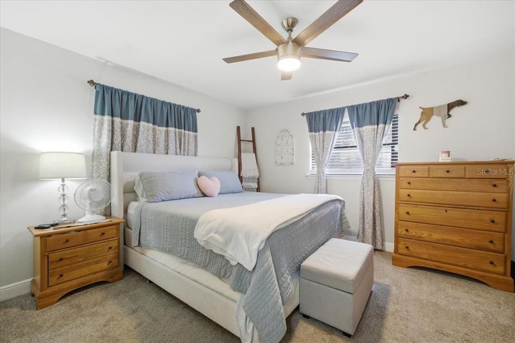 3487 Begonia Place Largo, FL 33771 - Photo 23 of 34 a bedroom with a bed and a dresser