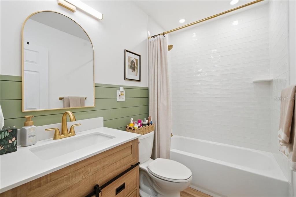 3487 Begonia Place Largo, FL 33771 - Photo 26 of 34 a bathroom with a sink toilet vanity and shower