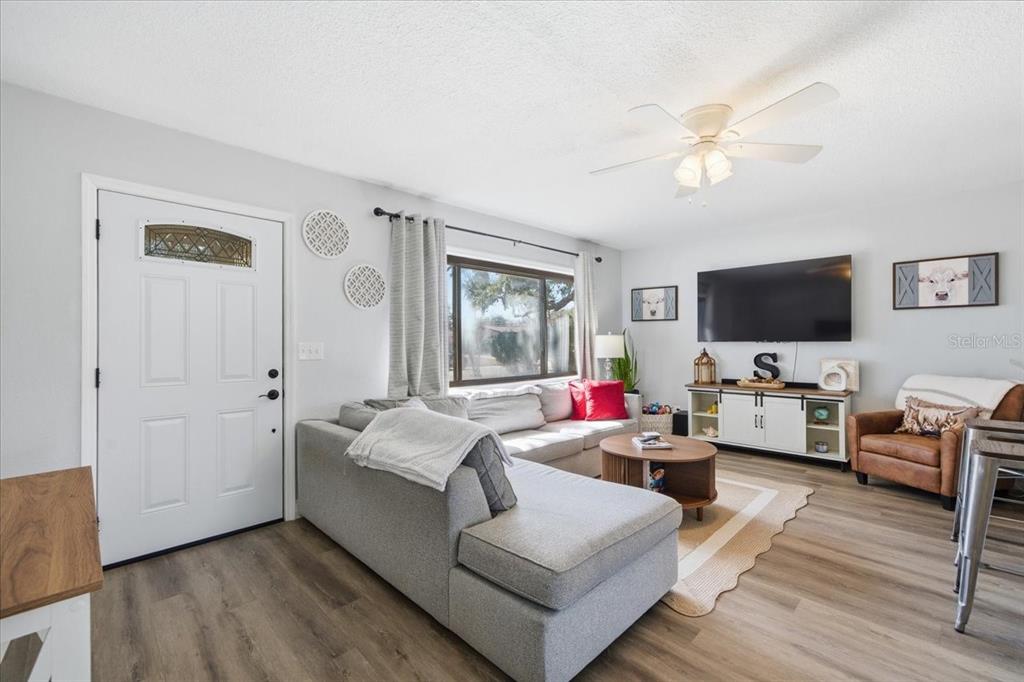 3487 Begonia Place Largo, FL 33771 - Photo 6 of 34 a living room with furniture and a flat screen tv