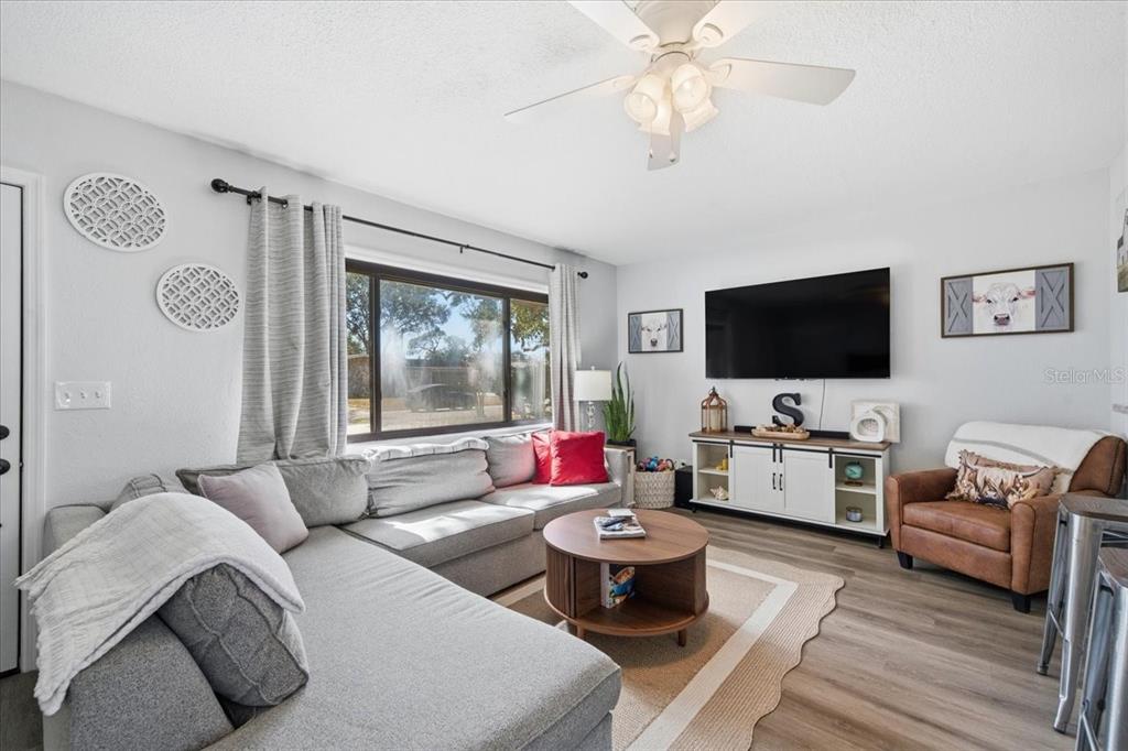 3487 Begonia Place Largo, FL 33771 - Photo 7 of 34 a living room with furniture and a flat screen tv
